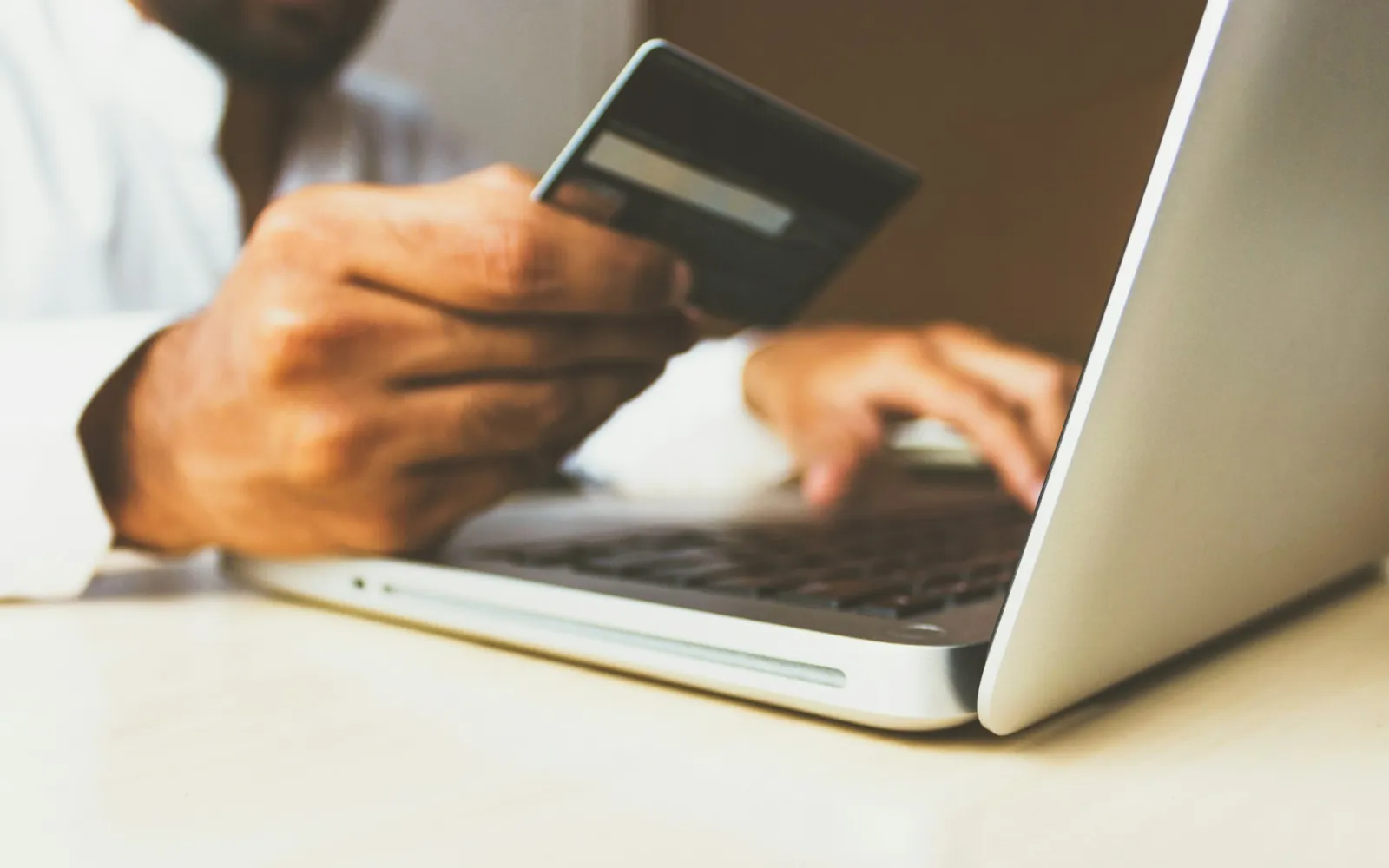 Paying online with a card at a laptop